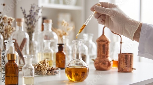 Person making perfumes in a laboratory setting