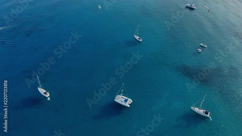 Sailboats and yachts on a clear blue ocean