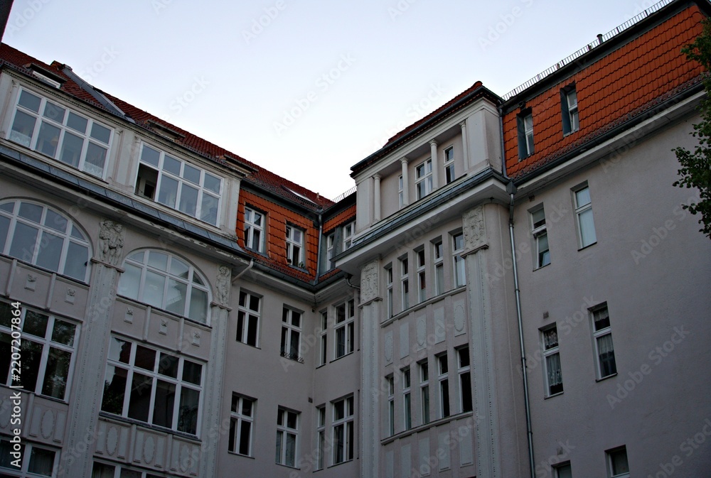 Fototapeta premium Apartment building with red tiled roofs and white windows