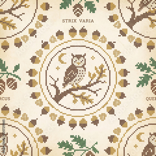 Seamless pattern featuring a decorative cross stitch owl perched on an oak branch with acorns and leaves in a vintage folk art style on a textured beige paper background design