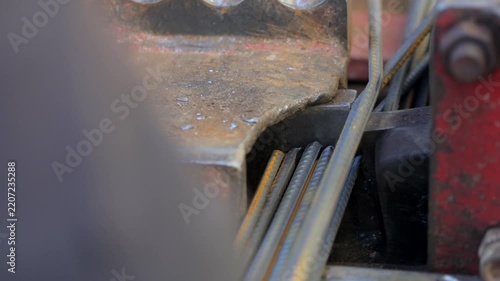 Close-up of a machine cutting steel reinforcing bars