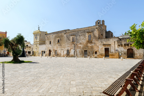 Wide angle view of Piazza Vittorio Veneto main square in the historic center of Avetrana, Puglia region, Italy. Sunny day featuring rustic ancient stone architecture,