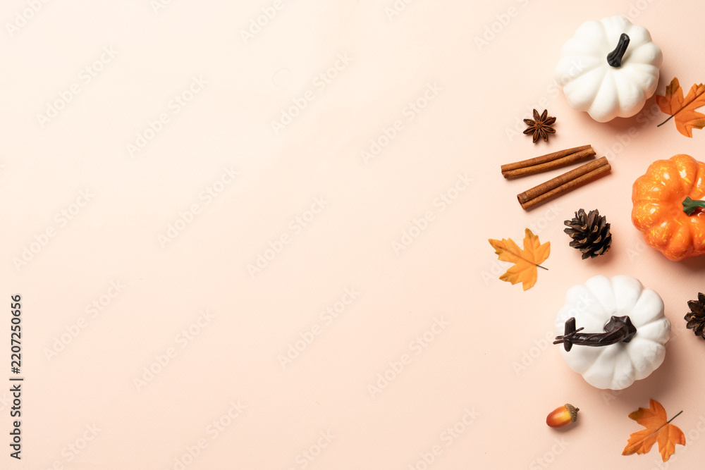Obraz premium Autumn flat lay background. Pumpkins, spices and fallen leaves on color background.