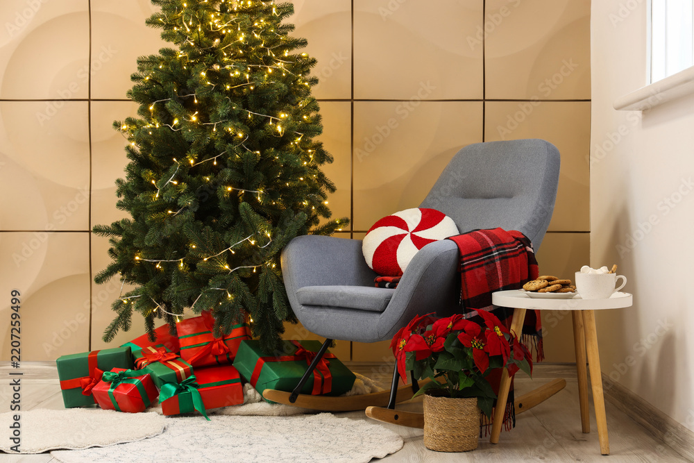 Obraz premium Christmas home comfort and holiday relaxation cozy living room interior with rocking chair decorated pine tree gifts and festive seasonal decorated
