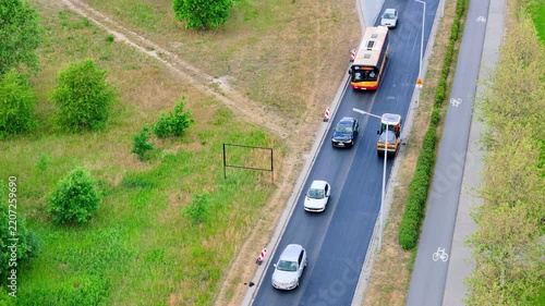 Aerial View of Road Construction and Traffic Flow in a Green Urban Landscape