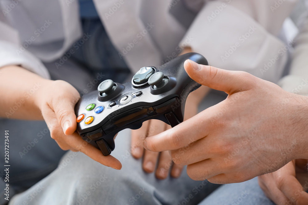 Fototapeta premium Gaming and social connection, couple playing video games together at home with a controller for entertainment and leisure time in a casual setting