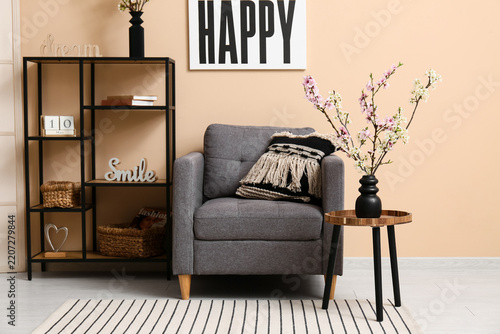 Home interior design and wellness, cozy living room with grey armchair and sp...