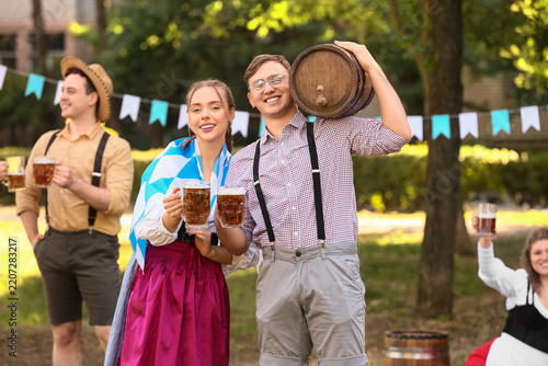 Oktoberfest celebration and beer festival, happy friends in traditional bavar...