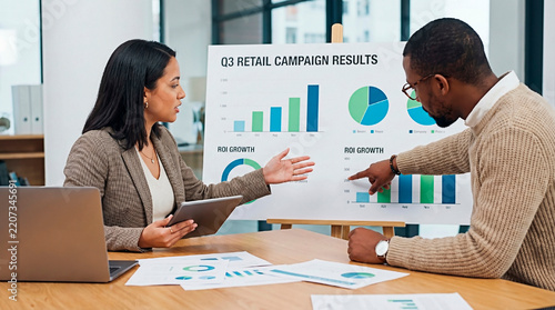 Two colleagues discussing business growth and strategy during a presentation.