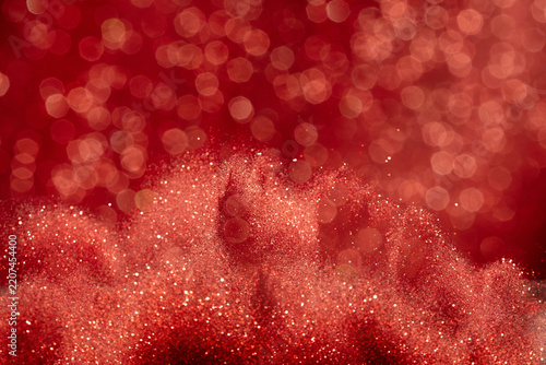 Abstract red glittering image evoked feelings of joy celebration. Background of red Sand powder glitter shimmered with golden sparkle, creating sparkling bokeh element wallpaper