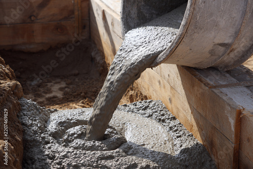 Flowing Cement into Construction Form for Strong Building Foundations
