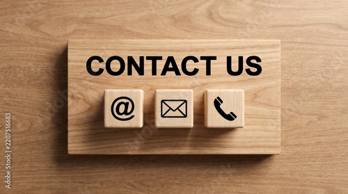 Contact Us wooden blocks with at sign, email, and telephone icons close-up, customer service and get in touch concept