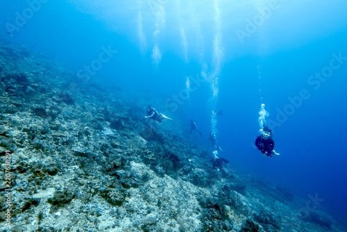 Fotografie Underwater coral reef with distant divers