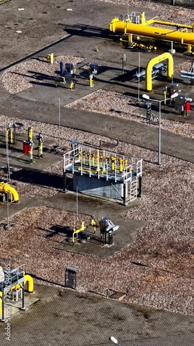 Industrial Natural Gas Facility With Yellow Gas Pipelines At The ORLEN Płock Production Plant In Płock, Mazovia, Poland. Vertical, Aerial Shot
