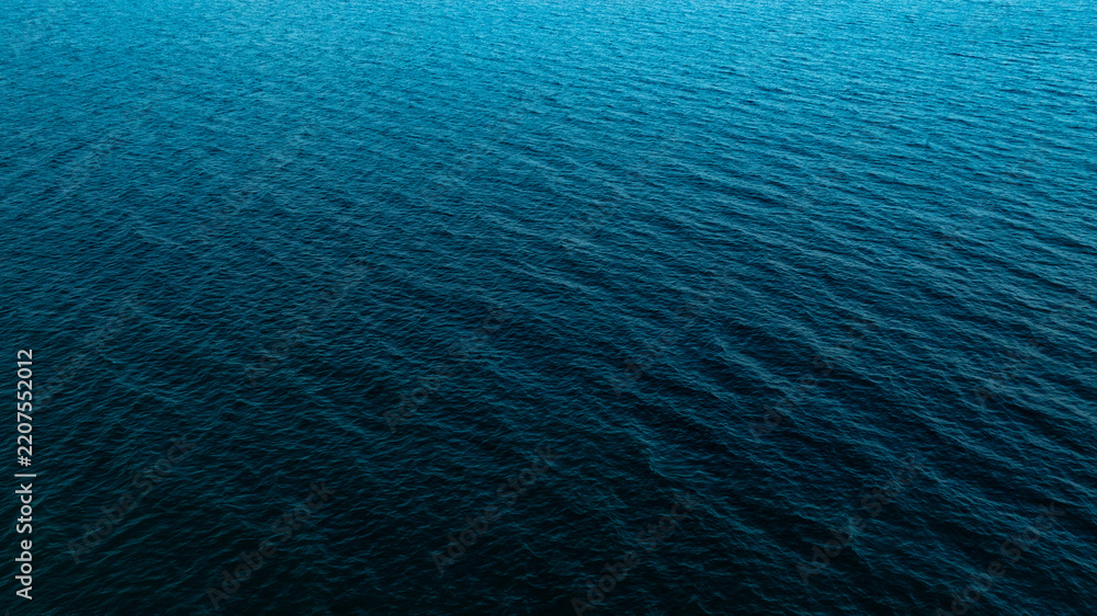 Naklejka premium Top view of deep blue sea water surface with small ripples, aerial drone shot of turquoise ocean texture at island , abstract nature background