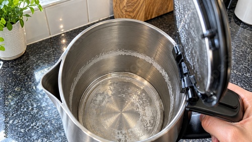 White limescale buildup inside electric kettle