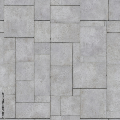 Gray stone tile wall with rectangular slabs in a clean staggered geometric pattern, showing subtle texture, seams, and natural marks.