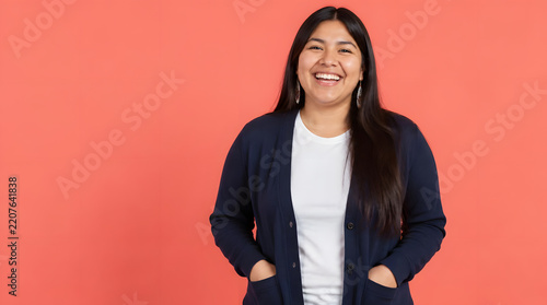 Joyful young woman with long dark hair smiling brightly at the camera.