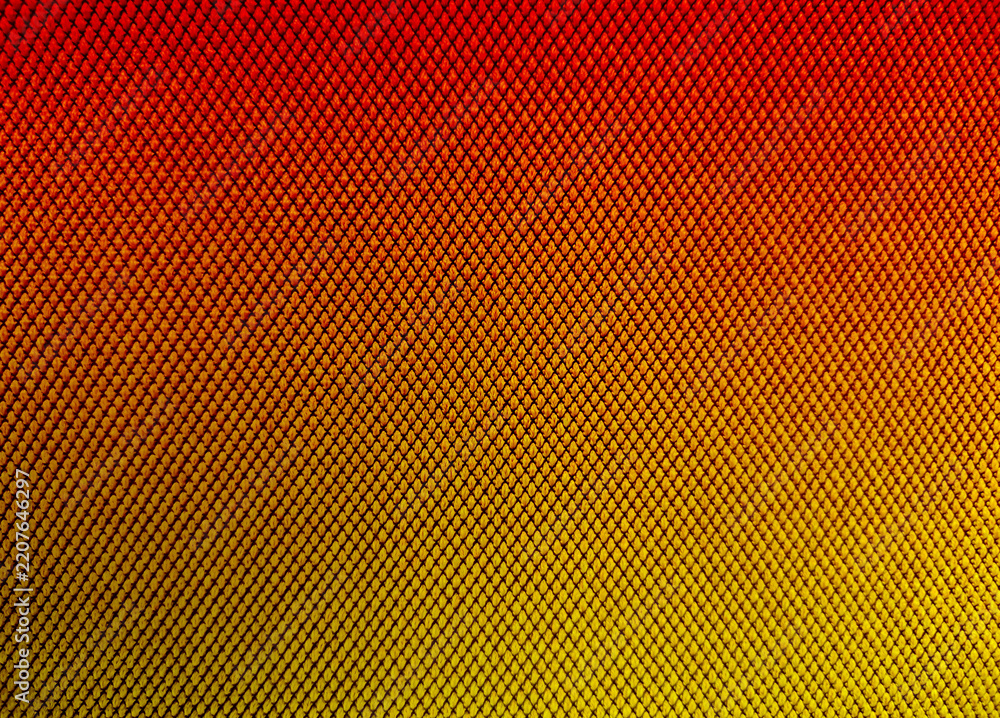 Obraz premium Vibrant Red to Yellow Gradient Carbon Fiber Mesh Grid Texture Surface Background