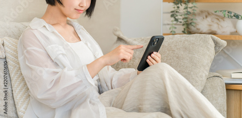 Teenage High School Girl Using a Smartphone at Home, Browsing Social Media Posts and Online Reviews