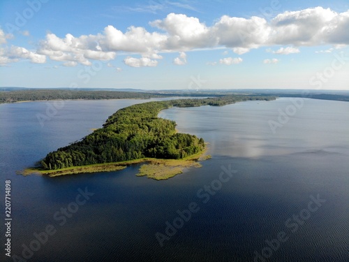 Long forested island dividing calm blue freshwater channels
