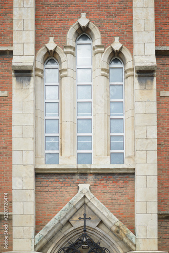 Brick Church Exterior with Gothic Windows and Cross