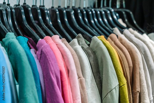Clothing rack with colorful apparel in a second hand store