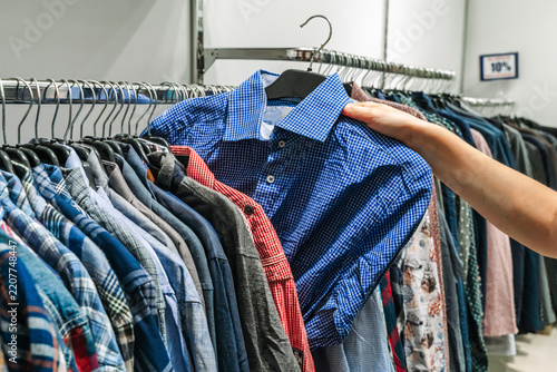 Clothing rack with colorful apparel in a second hand store