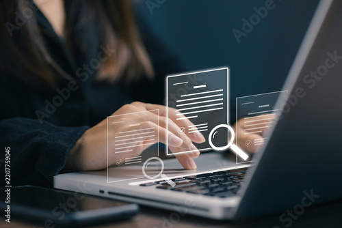 Business professional working on a laptop with virtual documents and search icons, representing online research, document review, data search, auditing, analysis, and information management.