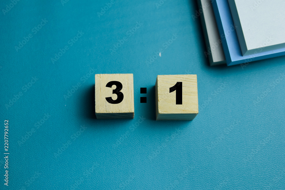 Obraz premium Three to one ratio text stacked wooden cubes on the table. For mathematical composition and finance