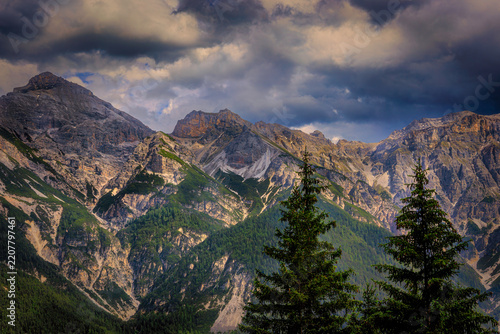 Dramatic alpine mountain range beneath storm clouds