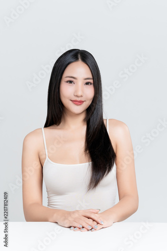 Happy young Asian woman with beauty face natural makeup and healthy black hair isolated on white background, for a perfectly woman, self care, cosmetics and wellness concept.