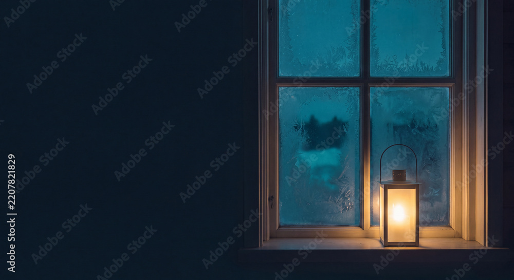 Fototapeta premium A luminous antique lantern stands on a rustic wooden window sill overlooking a serene twilight winter evening with warm light casting soft shadows across the frame