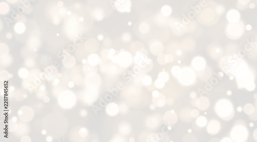 Diffuse golden bokeh lights create a warm and soft shimmering effect. The circular light spots vary in size and density across the dark background. This glowing pattern adds an elegant.