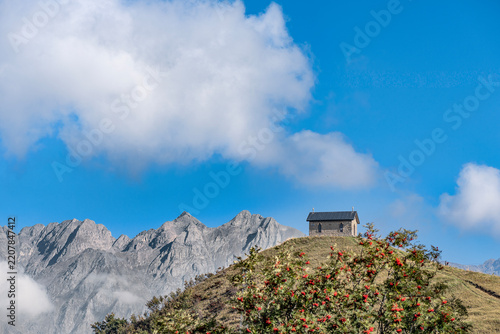 Bergamo Alps landscape with clouds and the church of Manina, Lombardy, Italy