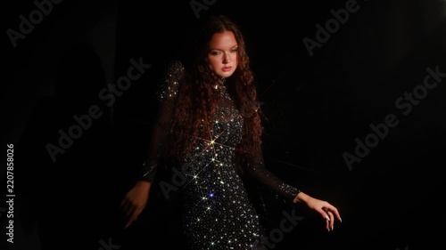 Dark banner with woman in a sparkling gown at the wall. Minimal low key frame with a large empty area on the right for headlines and advertising text.