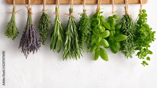 Fresh green herbs hanging to dry on wooden rack, natural kitchen decoration with vibrant leaves