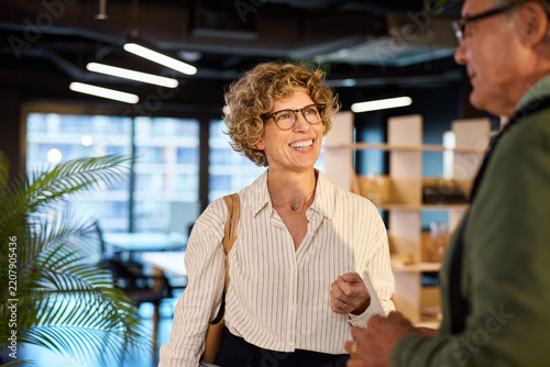 Happy business people discussing in modern office