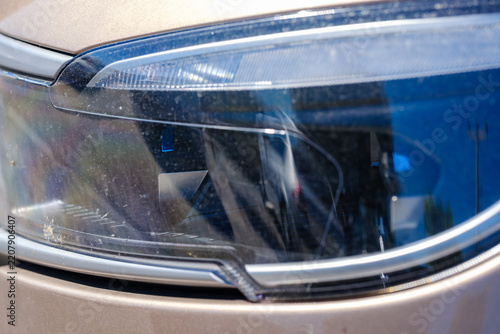 Detailed front LED headlight assembly and daytime running light styling on a bronze Togg T10X smart electric SUV crossover vehicle
