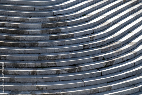 Curved stone steps showing wear and shadowed repetition