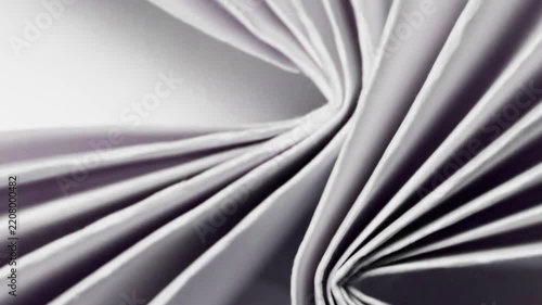 Crumpled paper smoothly transforms into a flat sheet in a creative transition, featuring realistic fibers, shadows, and natural movement for modern video content.