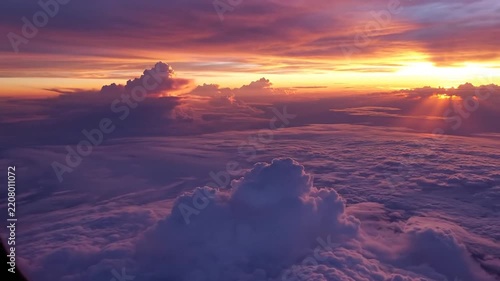 Aerial view of sunset over cloudscape from airplane window
