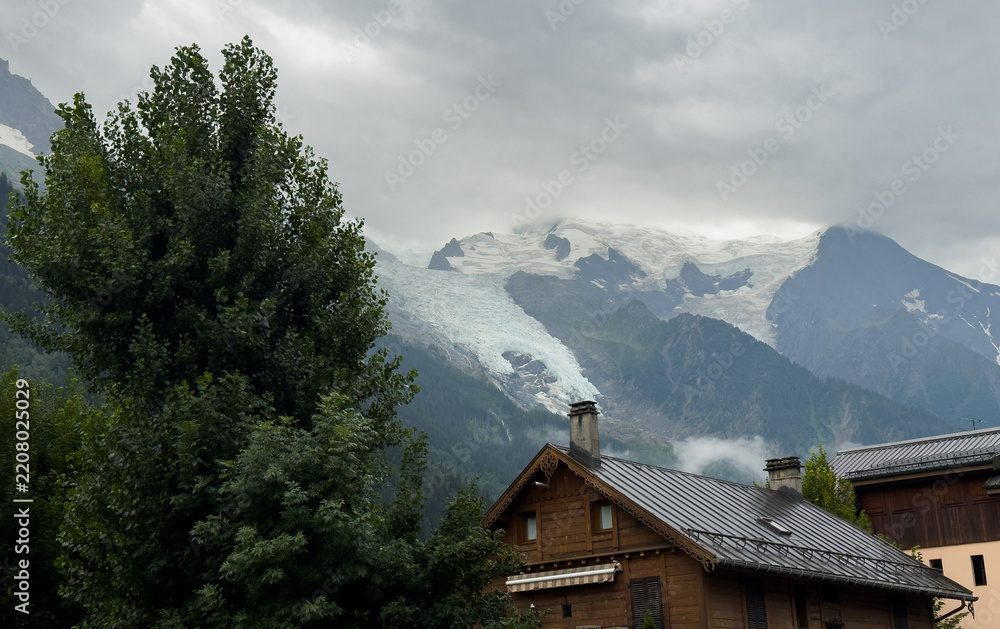 Obraz premium Summer view of the Mont Blanc massif above forested slopes 