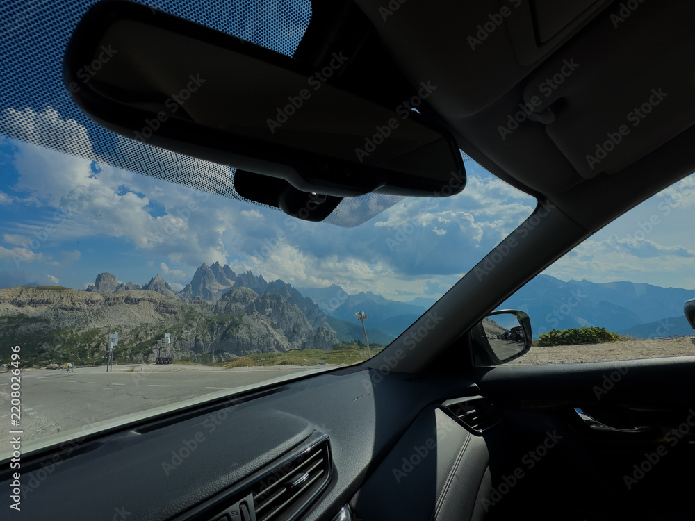 Obraz premium Mountains mirror on a road at sunset, concept of travel, journey, and looking back at the past. 