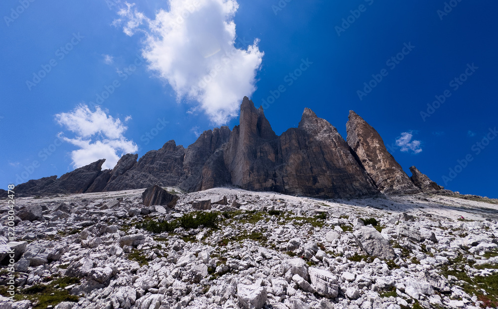 Obraz premium Mountain landscape panorama Tre Cime Mount against a blue summer background. 