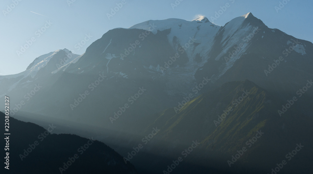 Obraz premium Summer view of the Mont Blanc massif above forested slopes 