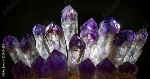 Glowing amethyst crystals against a dark background  in Austria