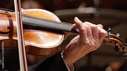 Close-up of a Musician Playing Classical Violin in a Symphony Orchestra