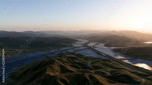 Aerial view of solar panels on rolling hills at sunset