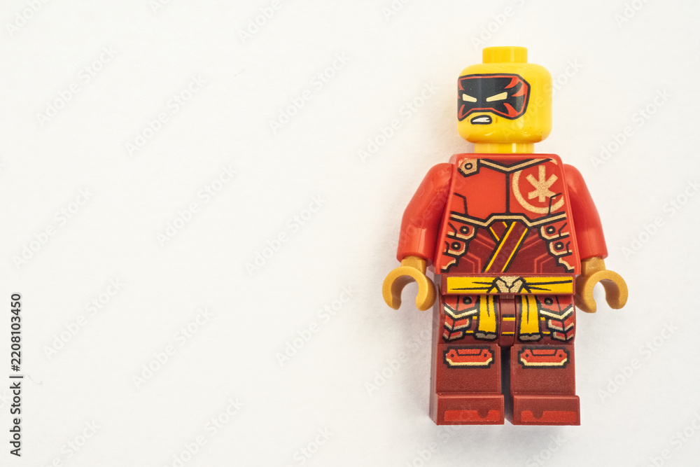 Obraz premium Kai lego mini figure from the Ninjago series, shot close-up and isolated on a white paper background. Seen here wearing a black and red mask. Bradford, UK.Sep 28 2026